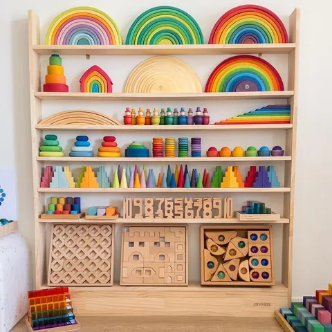 A shelf full of colourful wooden toys